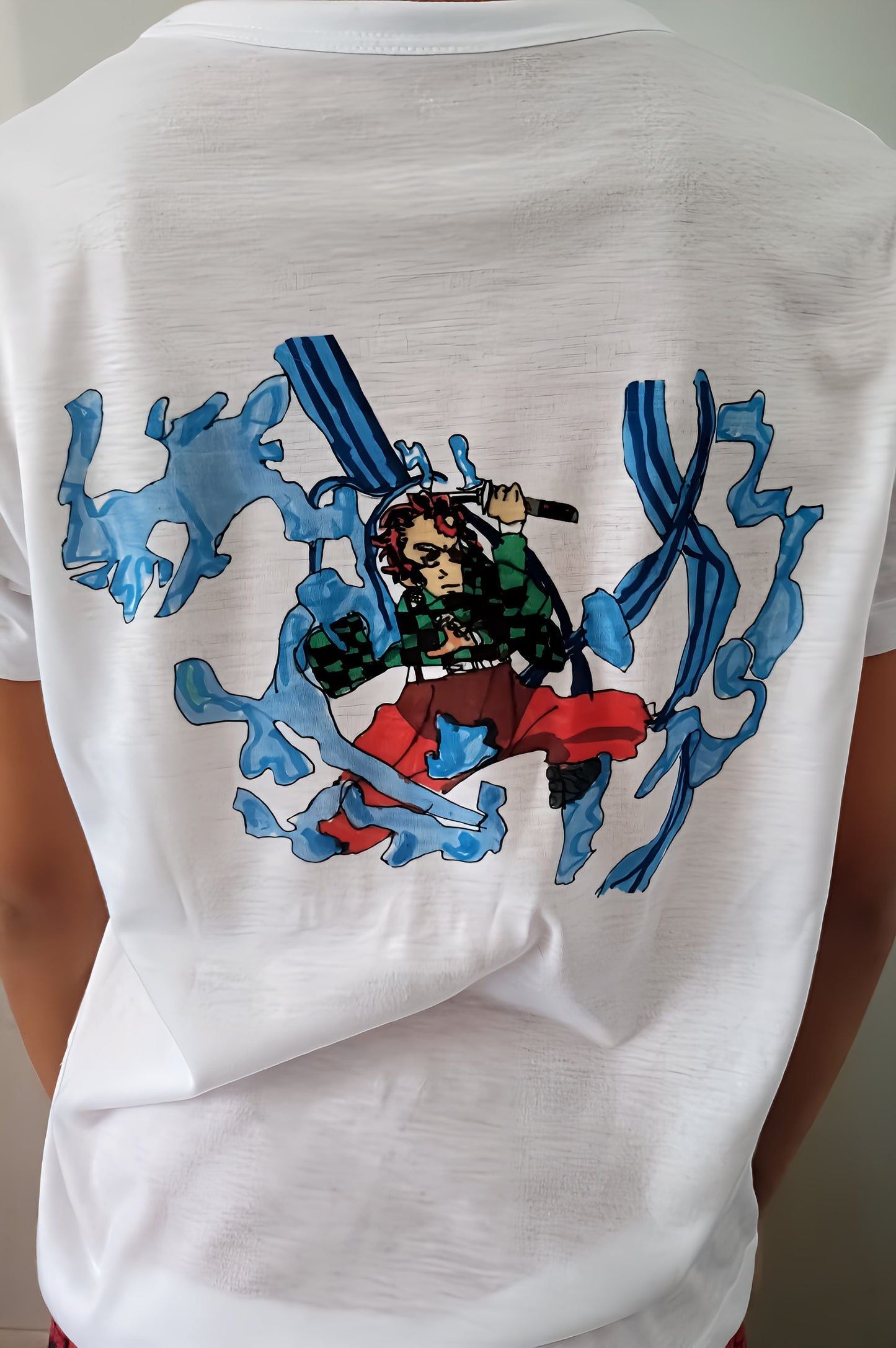 White t-shirt with anime character and blue water splash graphic on the back