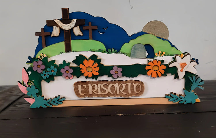 Easter resurrection scene wood decor with flowers, crosses, empty tomb, and 'E RISORTO' text