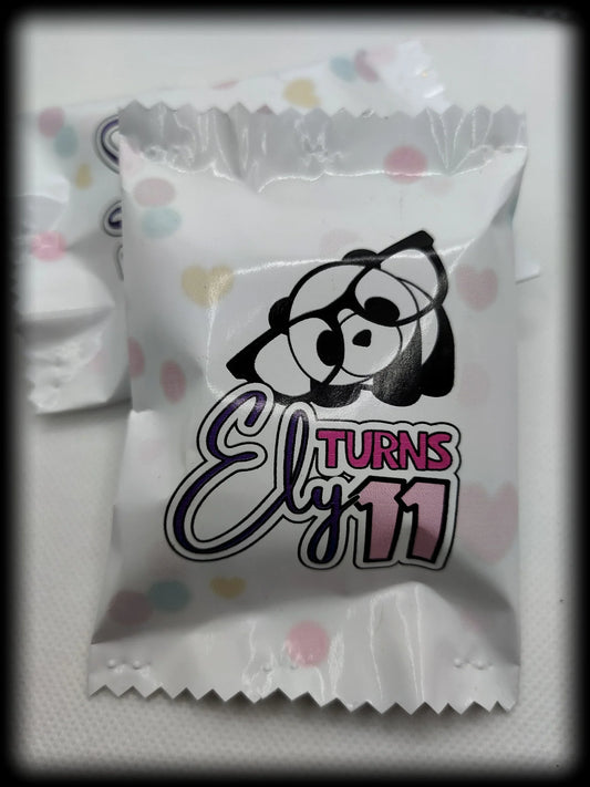 Custom party candy wrapper with cartoon bear and text 'Ely turns 11' on pastel polka dot background
