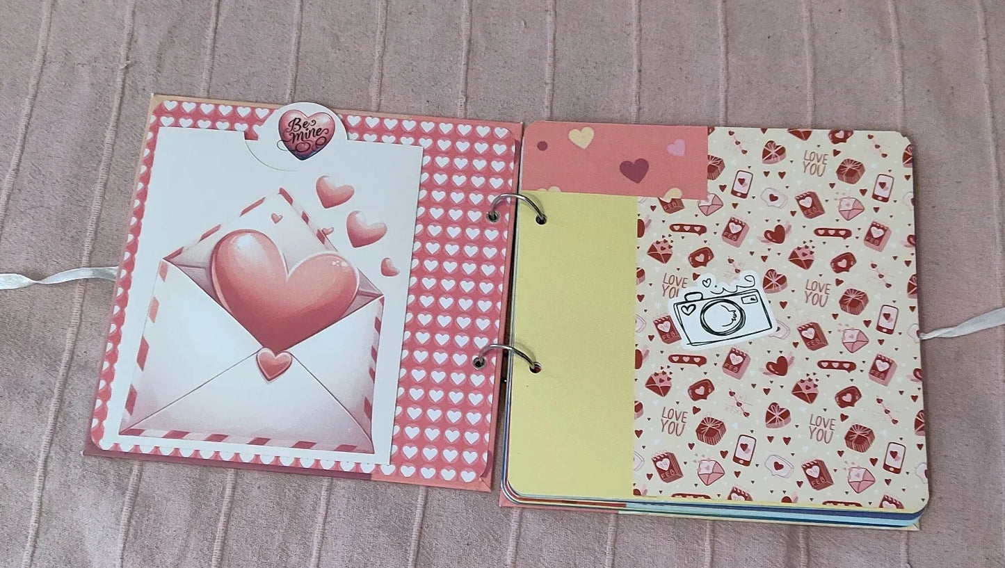 Valentine scrapbook with pink hearts, love letter, and decorative camera sticker