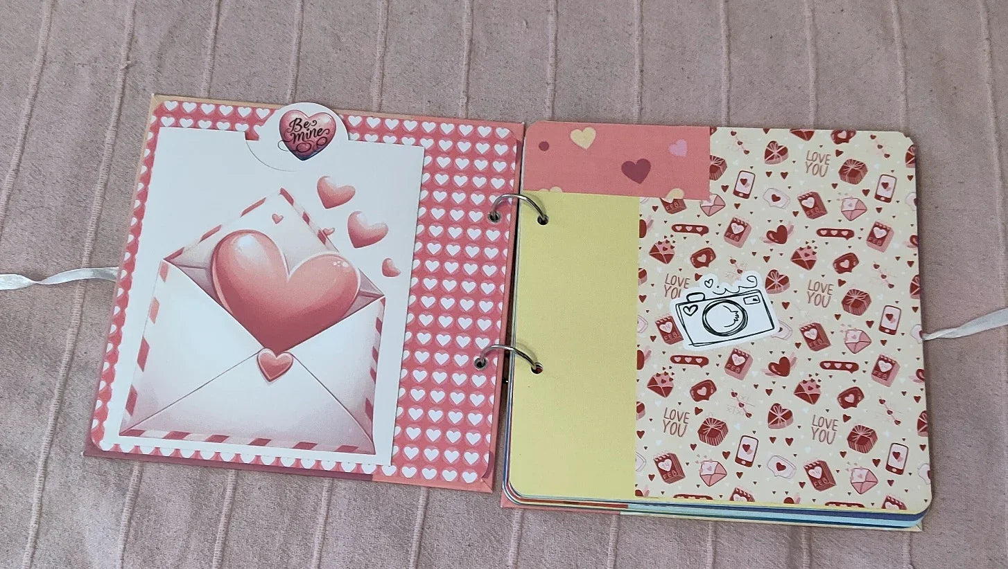 Valentine scrapbook with pink hearts, love letter, and decorative camera sticker