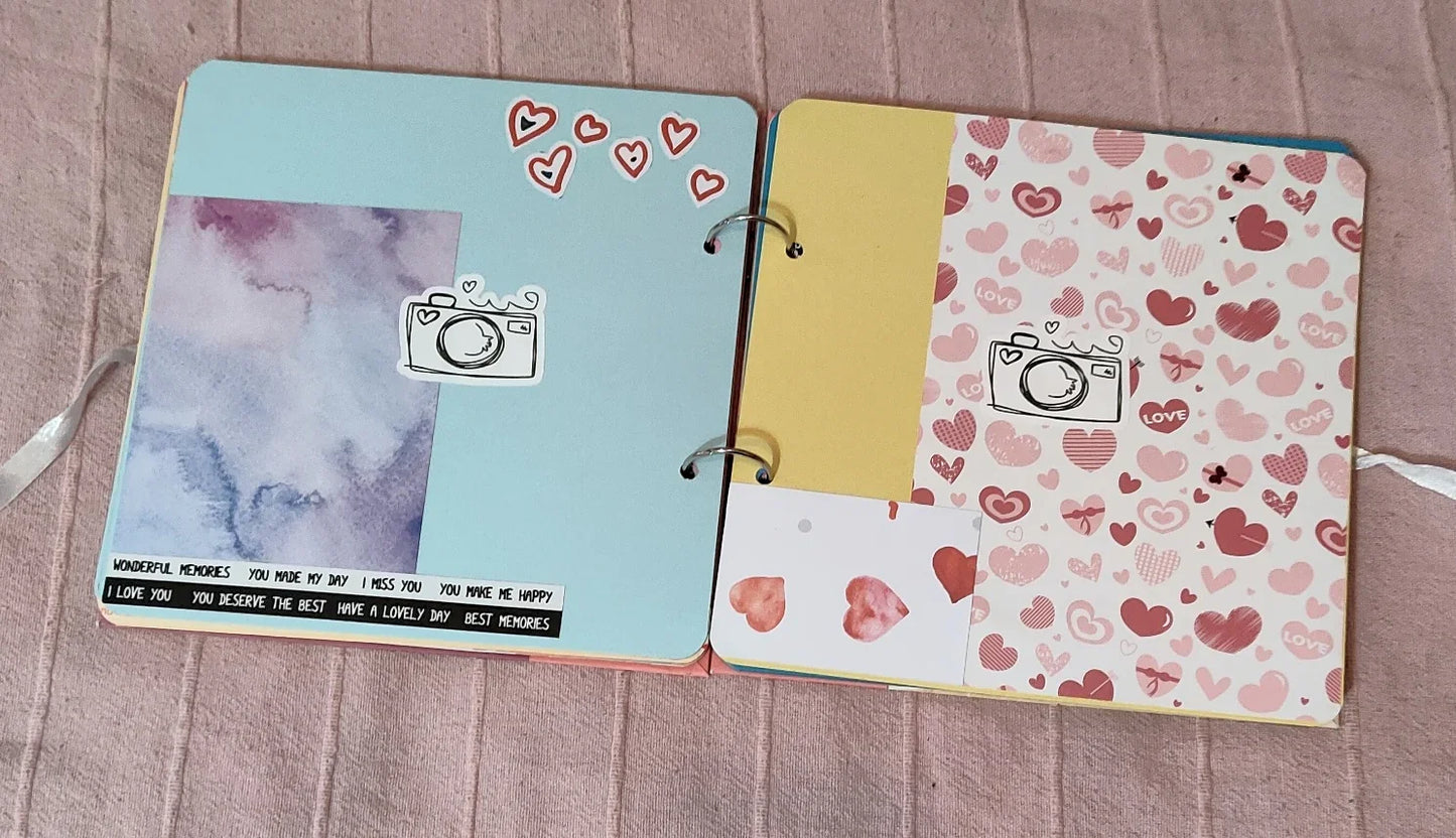 Cute handmade scrapbook pages with heart and camera stickers, pastel colors and love messages