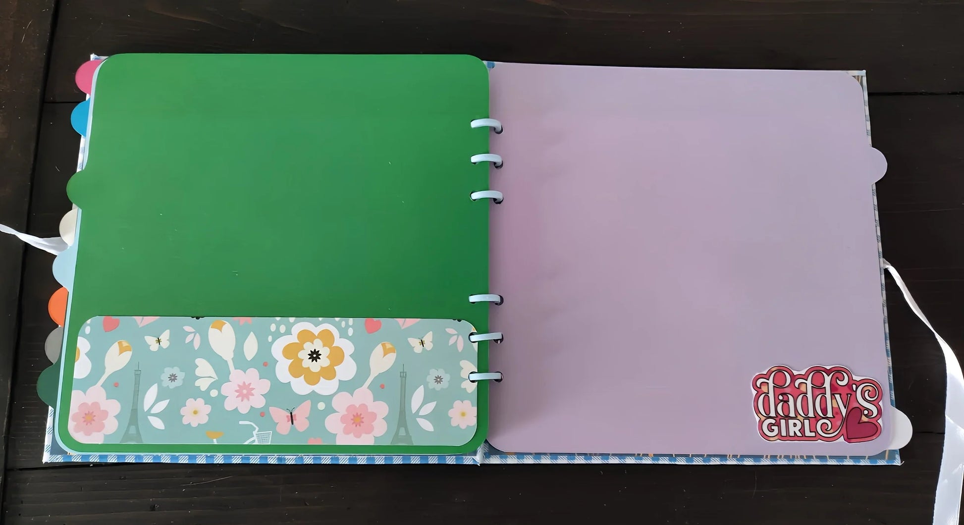 Open scrapbook with green and purple pages, floral accent, and Daddy's Girl sticker