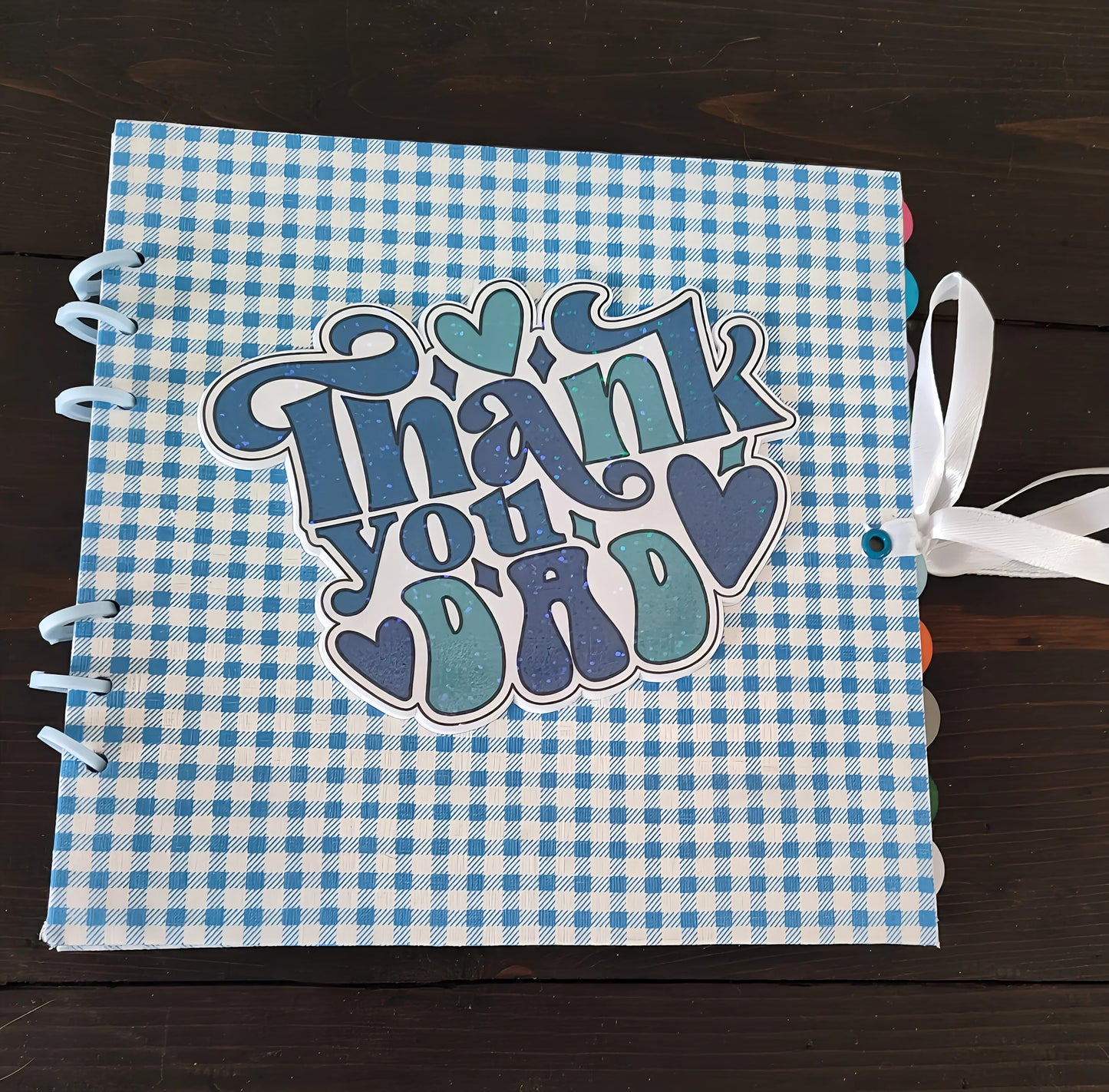 Blue plaid scrapbook with 'Thank you Dad' and hearts, tied with a white ribbon