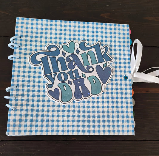 Blue plaid scrapbook with 'Thank you Dad' and hearts, tied with a white ribbon