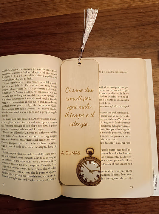 Wooden bookmark with Italian quote and pocket watch illustration on open book, wooden table