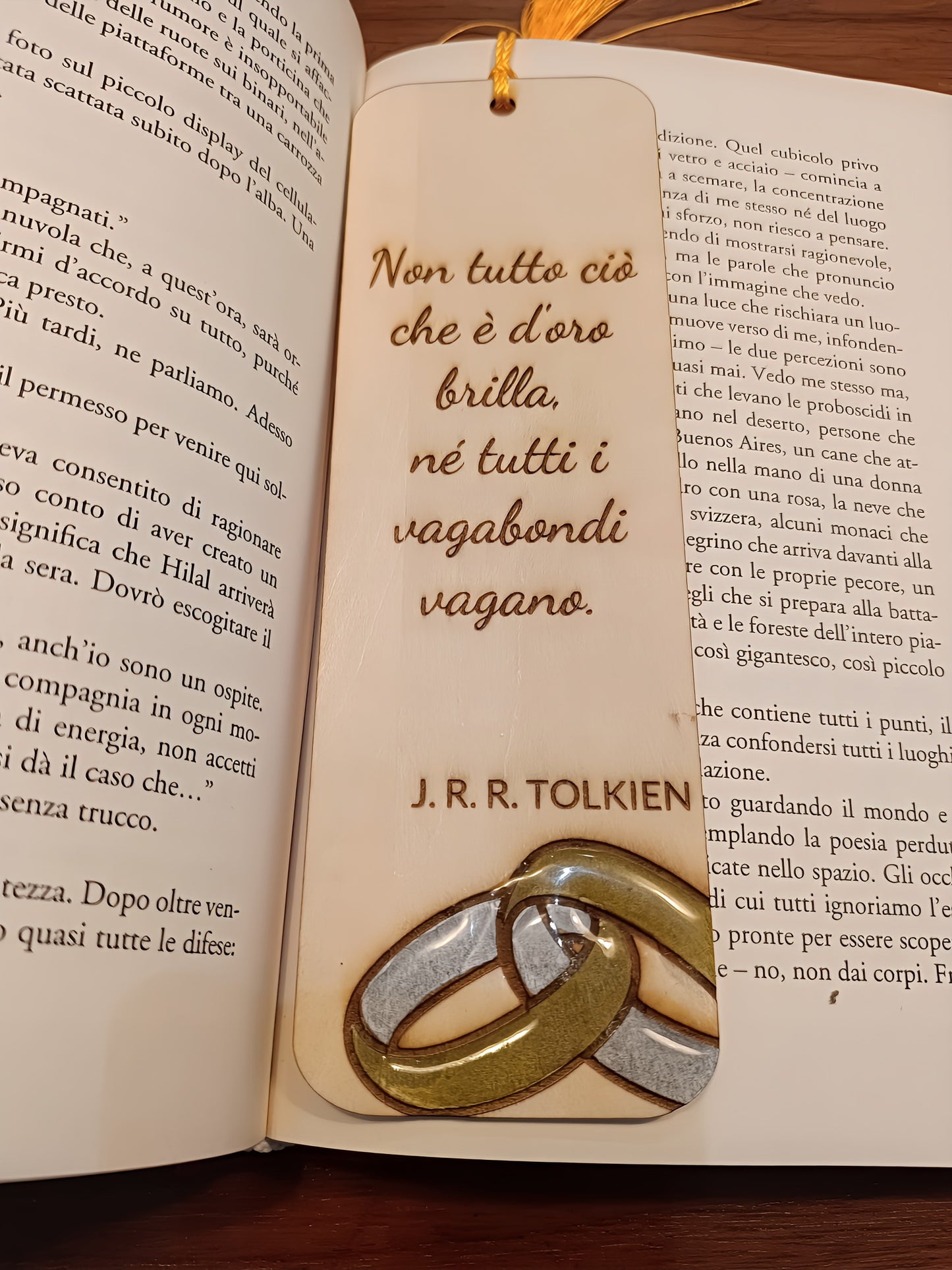 Italian Tolkien quote bookmark with two rings on open book, fantasy literature reading scene
