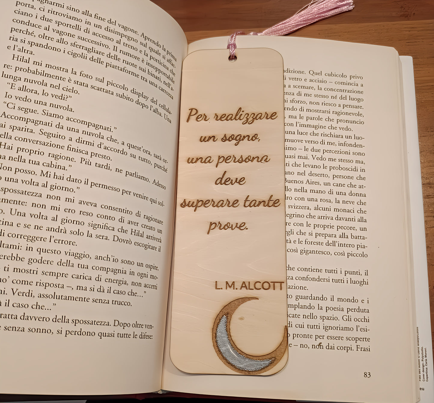 Open book with an engraved bookmark featuring an inspirational L. M. Alcott quote and a crescent moon design