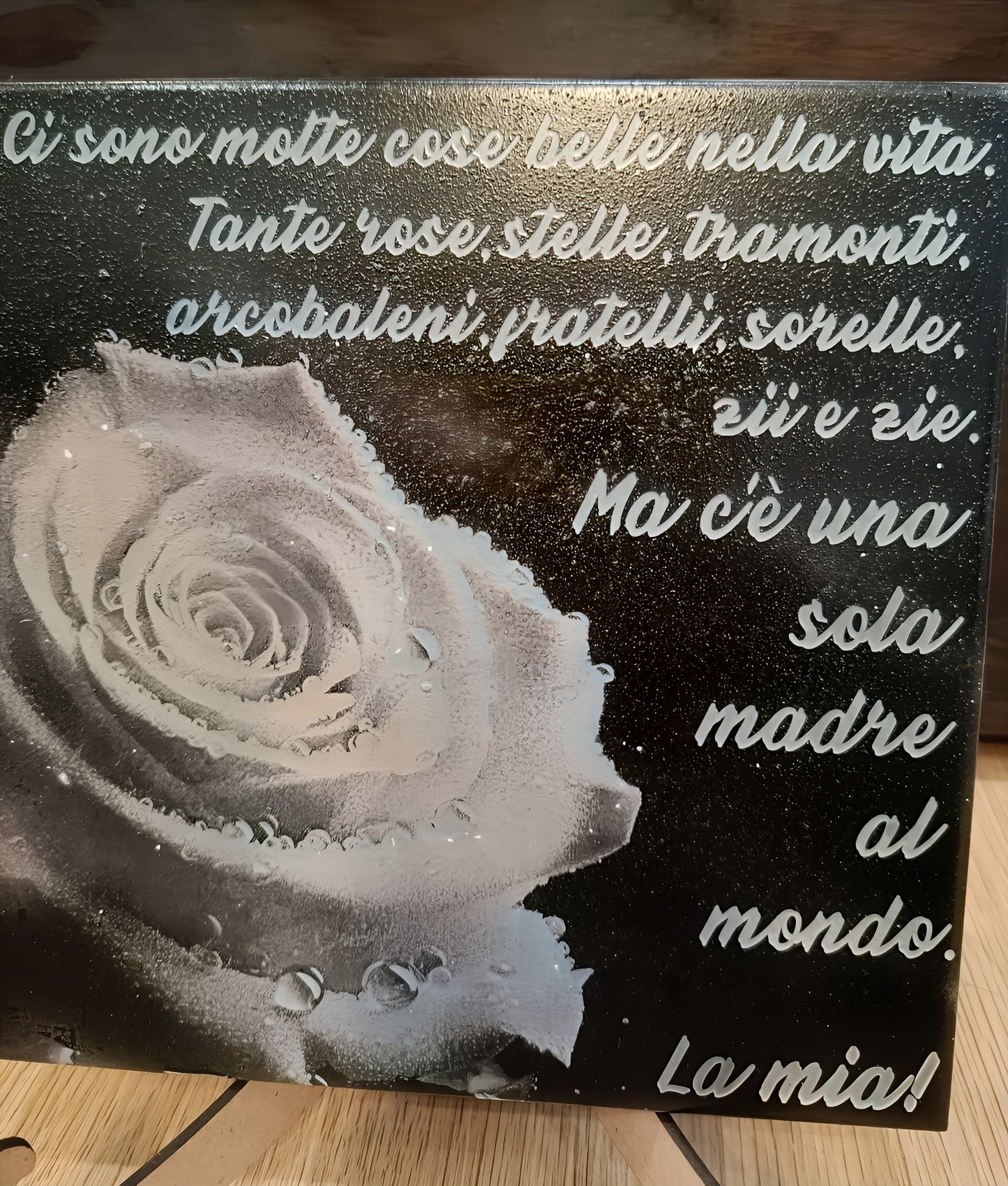 Decorative plaque with Italian mother quote and a white rose on a black background