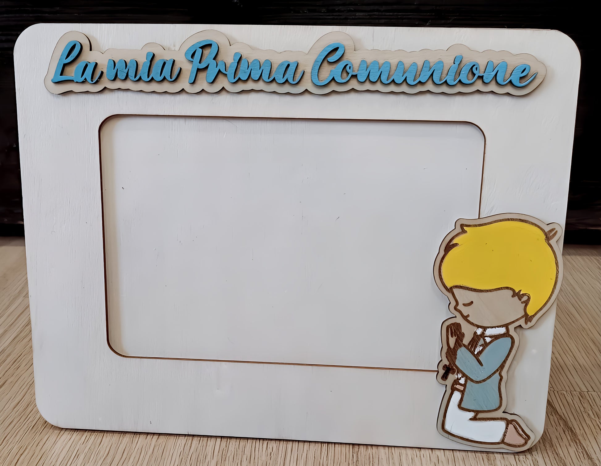 Wooden photo frame with 'La mia Prima Comunione' text and kneeling boy illustration