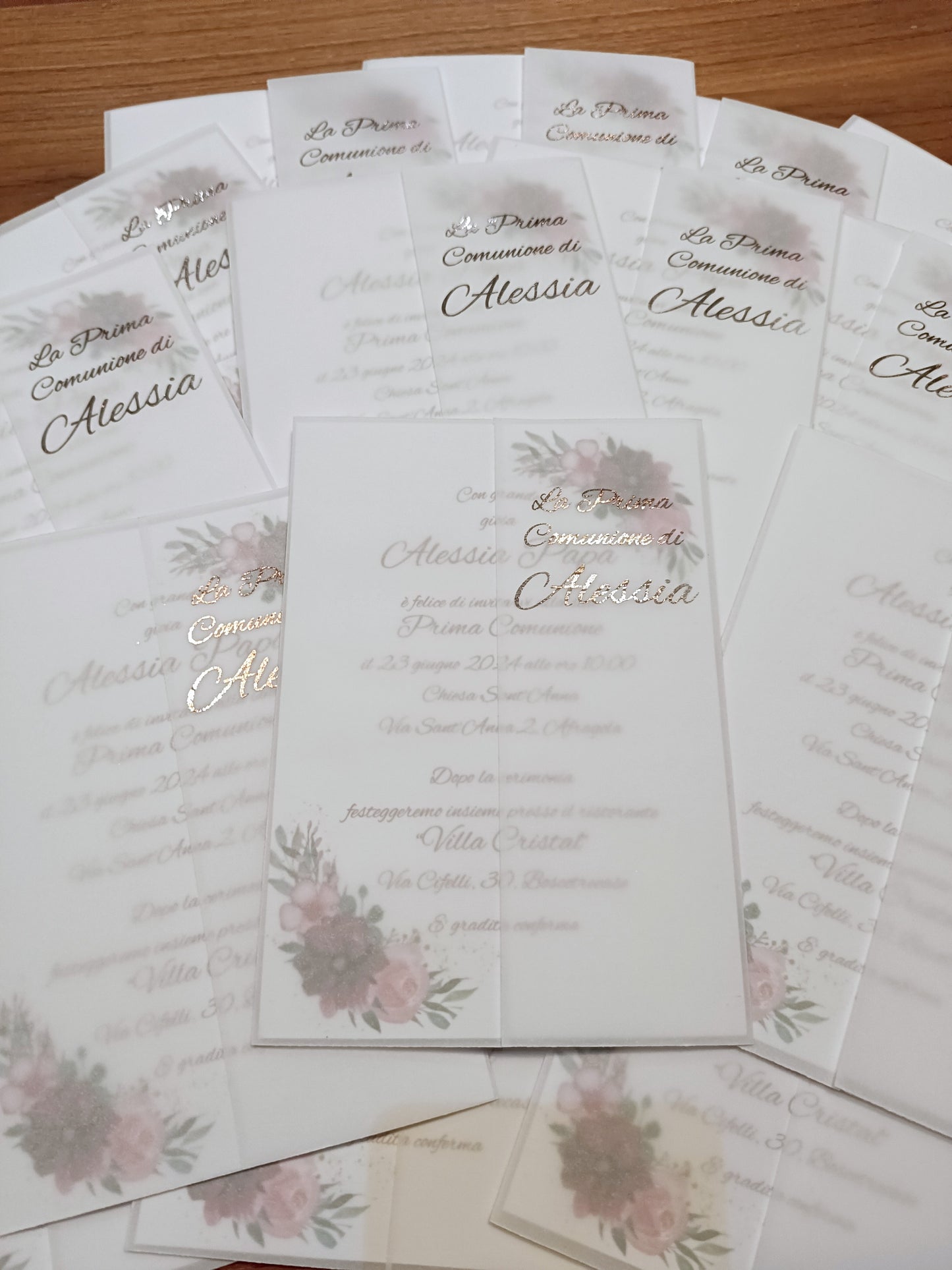 Elegant floral first communion invitations for Alessia on wooden table