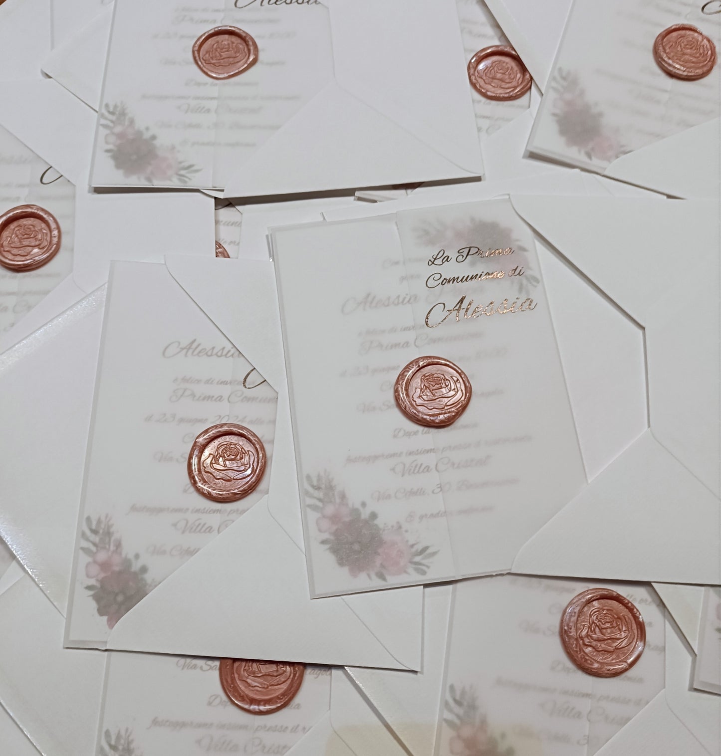Elegant white invitations with wax seals and floral designs for First Communion event