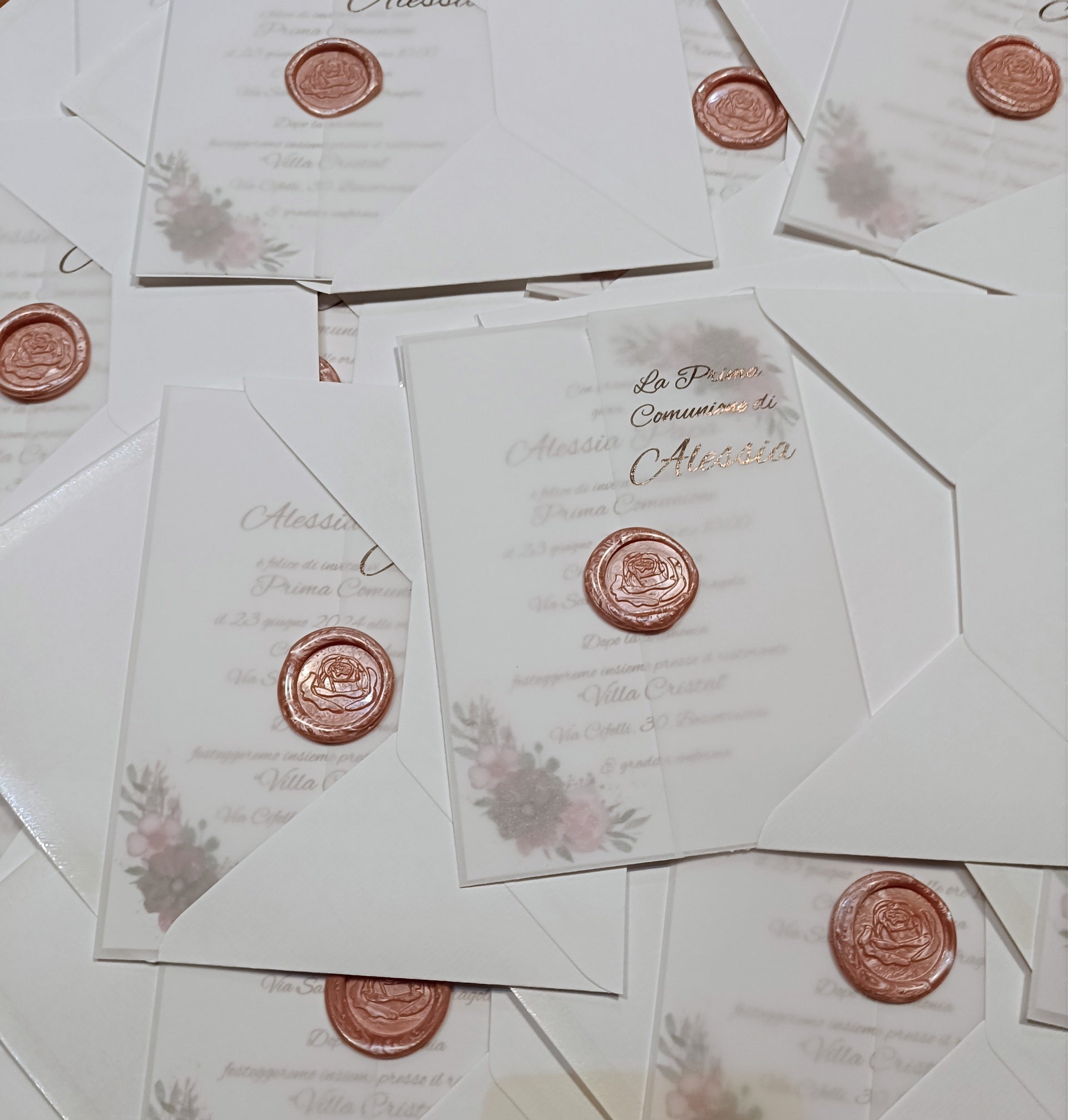 Elegant white invitations with wax seals and floral designs for First Communion event