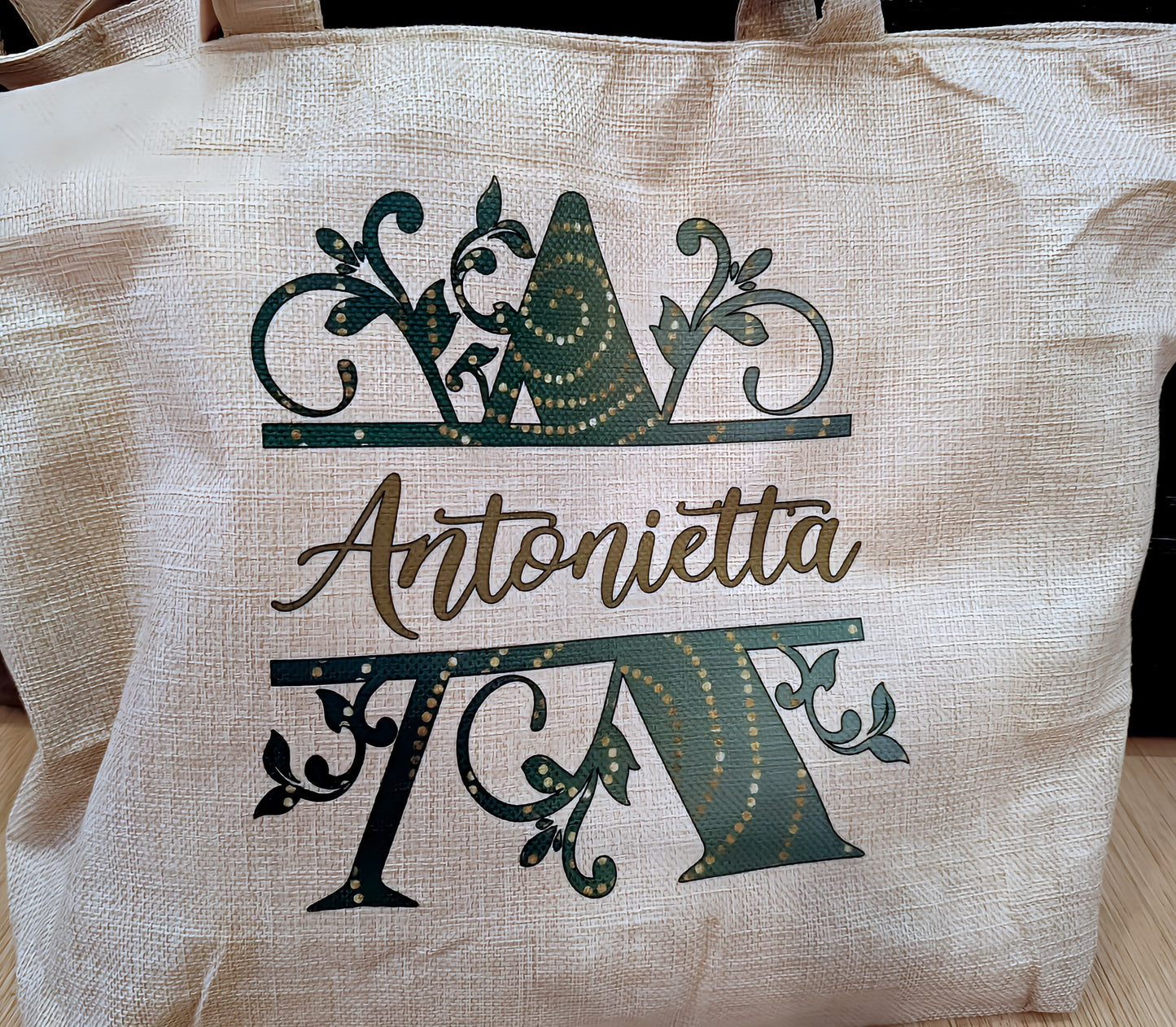 Personalized beige tote bag with green floral letter A and Antonietta text design
