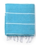 Folded blue Turkish towel with white stripes and fringe, cotton beach towel