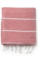 Folded pink cotton towel with white stripes and fringe edges