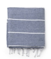 Folded blue Turkish towel with white stripes and fringed edges