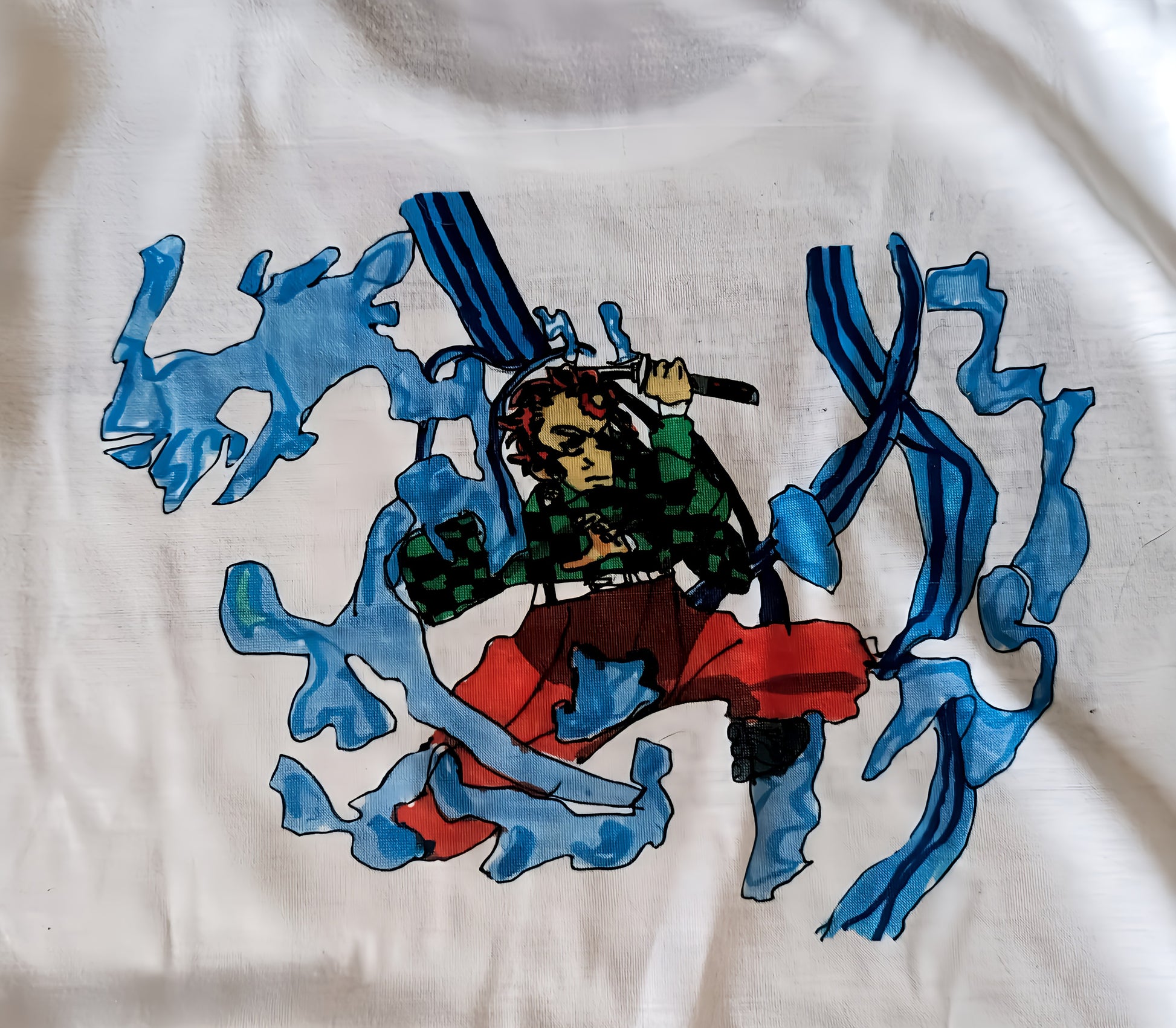 Anime character with sword and blue water effects on white fabric, graphic illustration