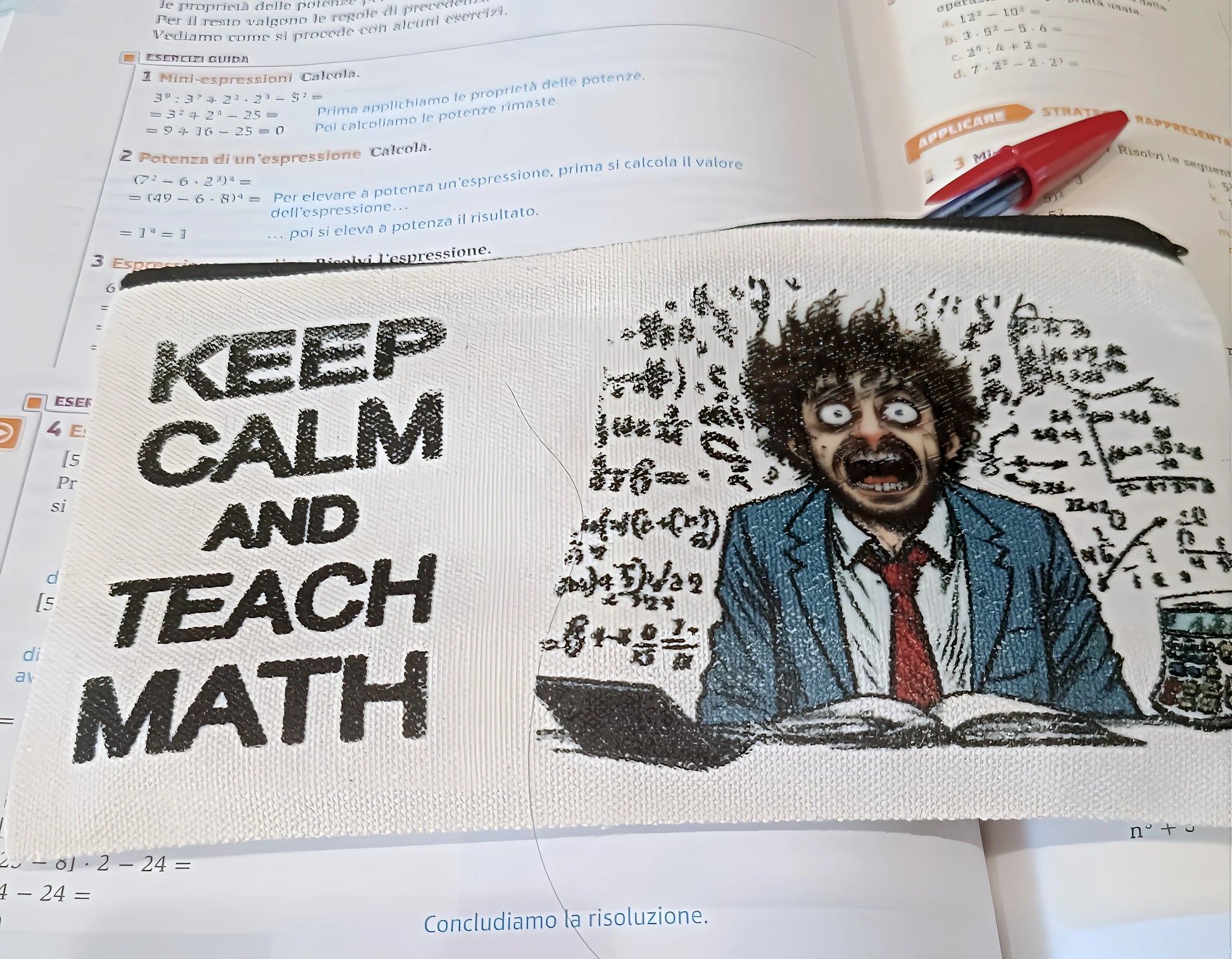 Math pencil case with 'Keep Calm and Teach Math' and a stressed teacher cartoon, on textbook