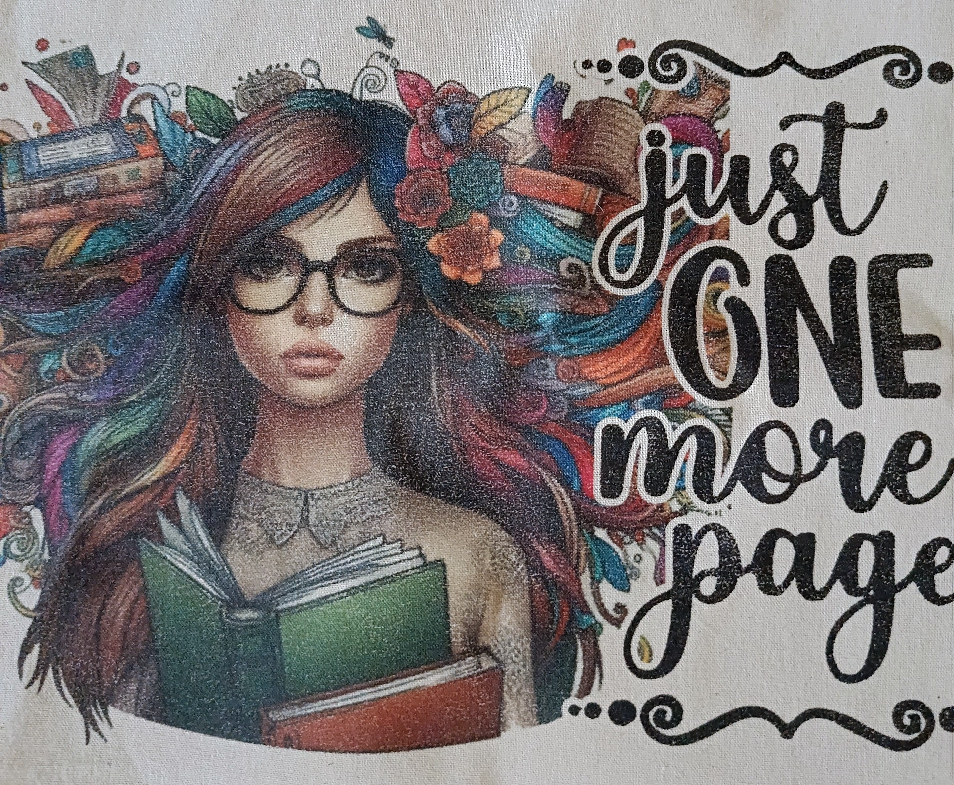 Illustration of woman with glasses, colorful hair, books, and 'just one more page' text