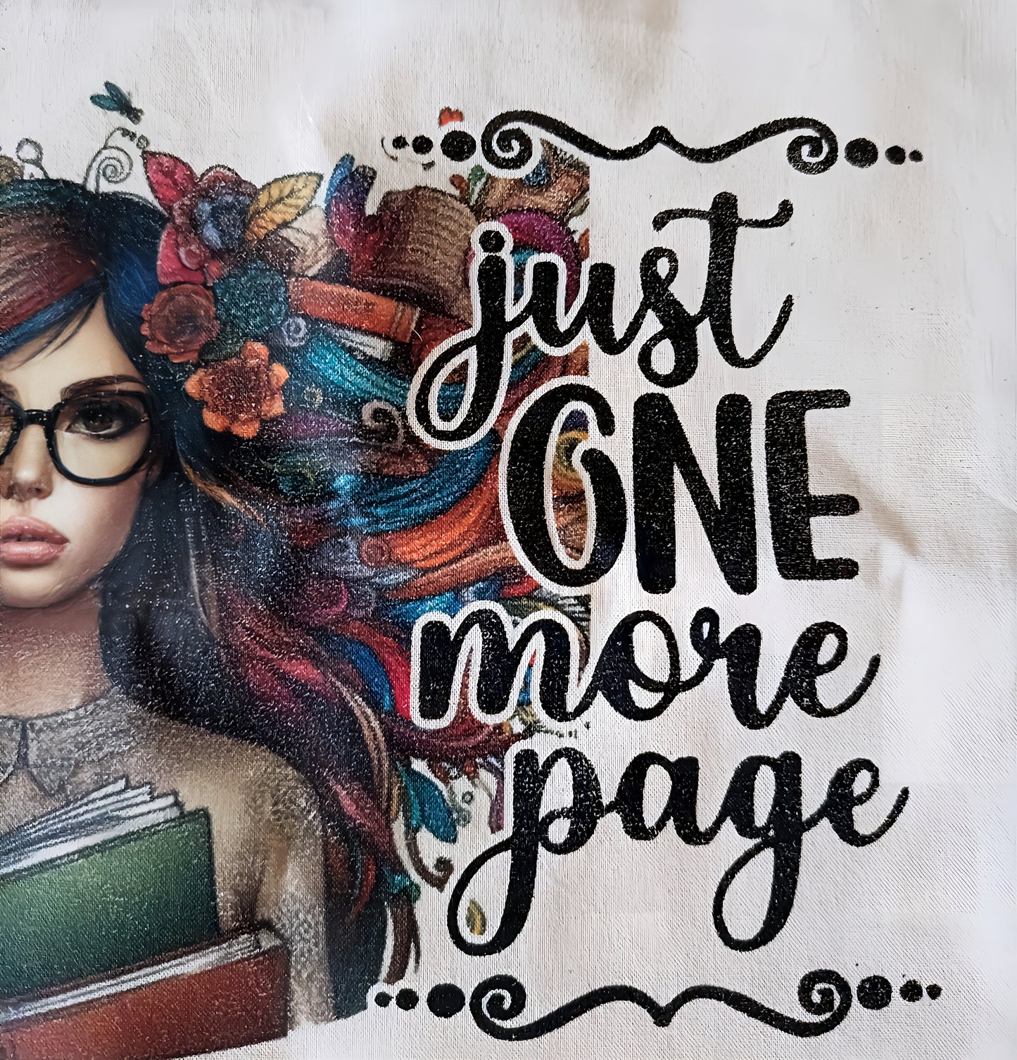 Girl with glasses and colorful hair holding books, text says 'just one more page'
