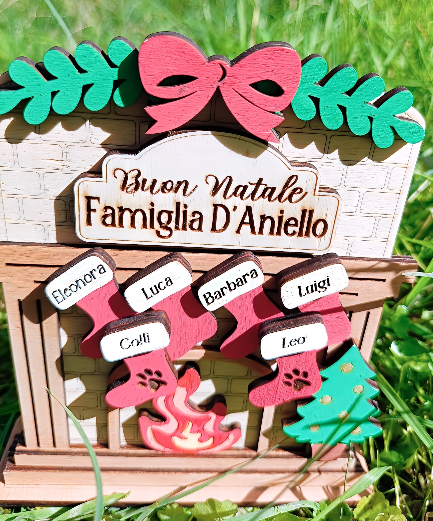 Personalized Buon Natale Famiglia D'Aniello Christmas decoration on grass with stockings and tree