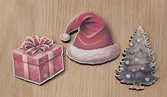 Christmas stickers of a gift box, Santa hat, and Christmas tree on wooden background