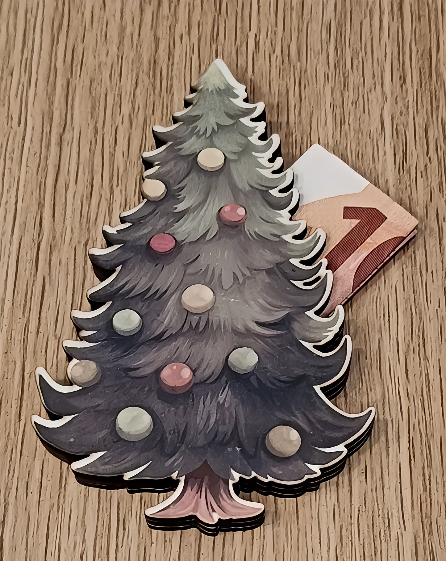 Christmas tree card with euro bill on wooden table, festive holiday gift concept