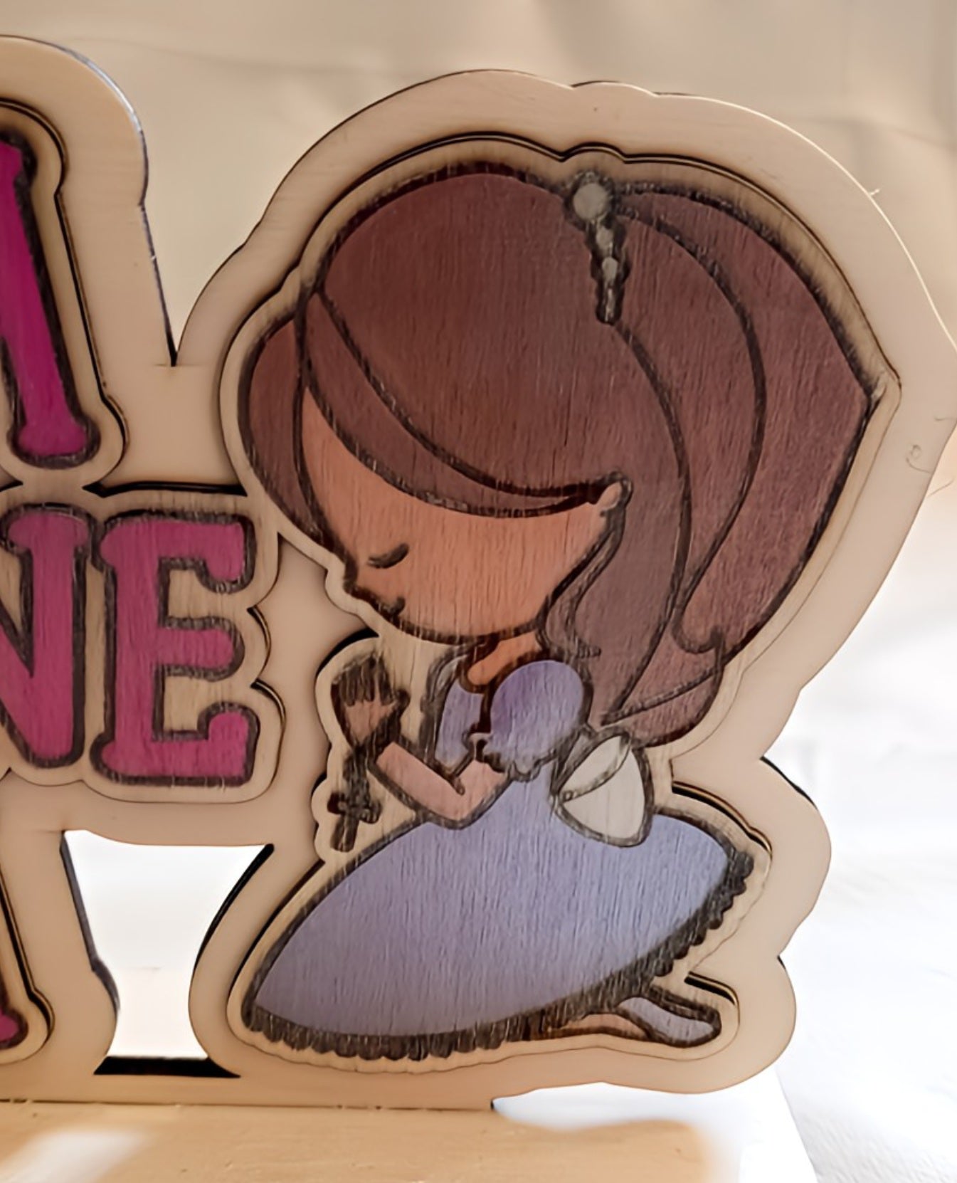 Wooden cutout of cartoon girl in purple dress praying, white background, laser-engraved art