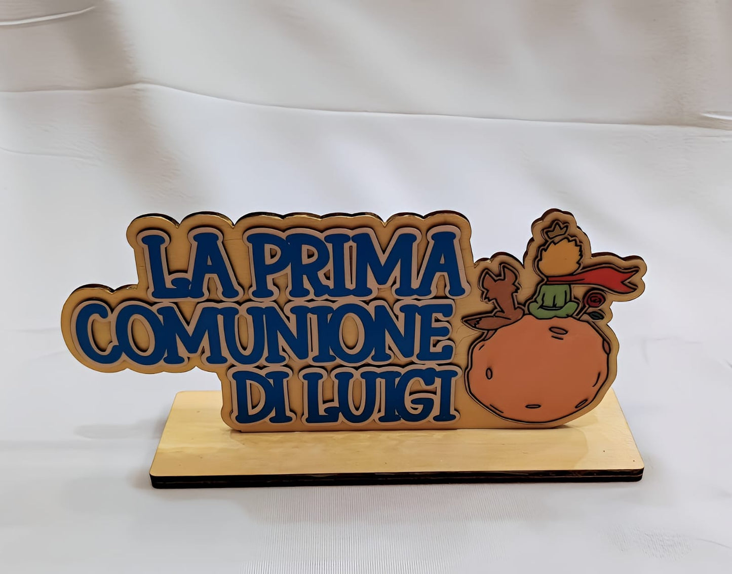 Wooden plaque for Luigi's first communion with blue Italian text and Little Prince illustration
