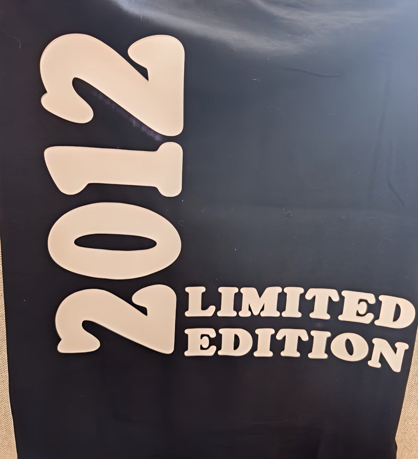 2012 limited edition bold beige text on black background