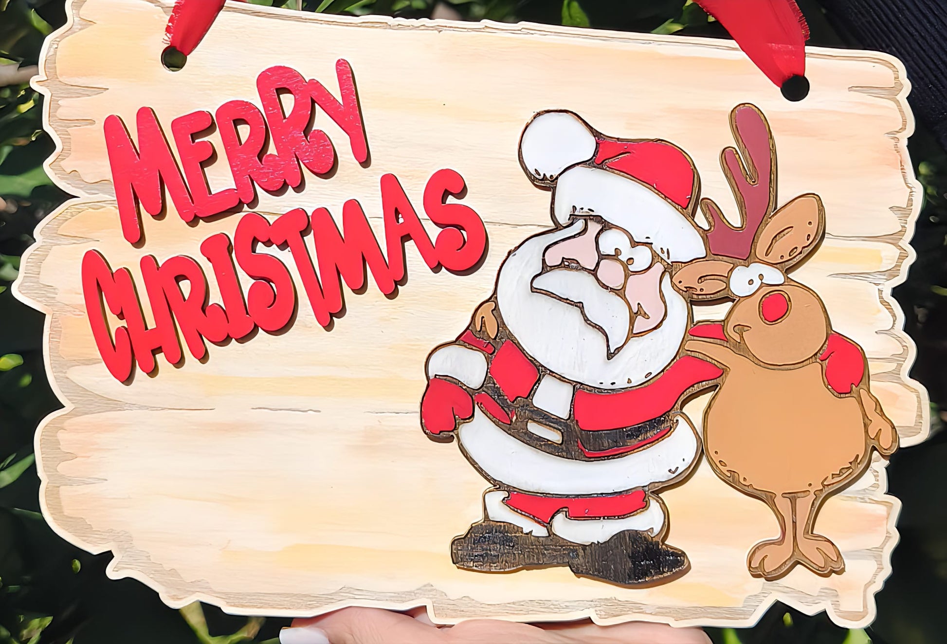 Wooden sign with Santa Claus and reindeer cartoon, red Merry Christmas text, festive decor