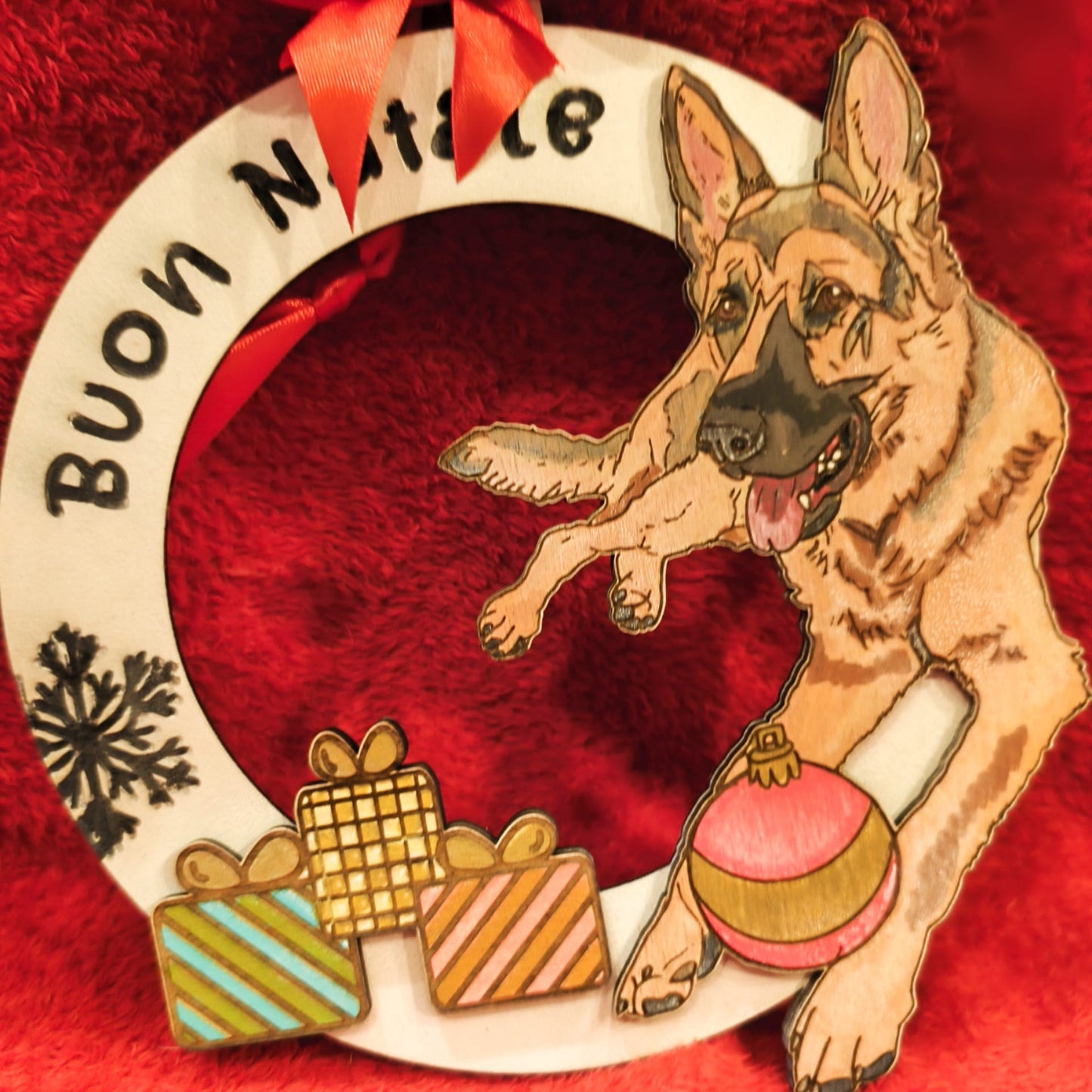 Buon Natale wreath with German Shepherd dog, Christmas gifts, ornament, and snowflake on red background