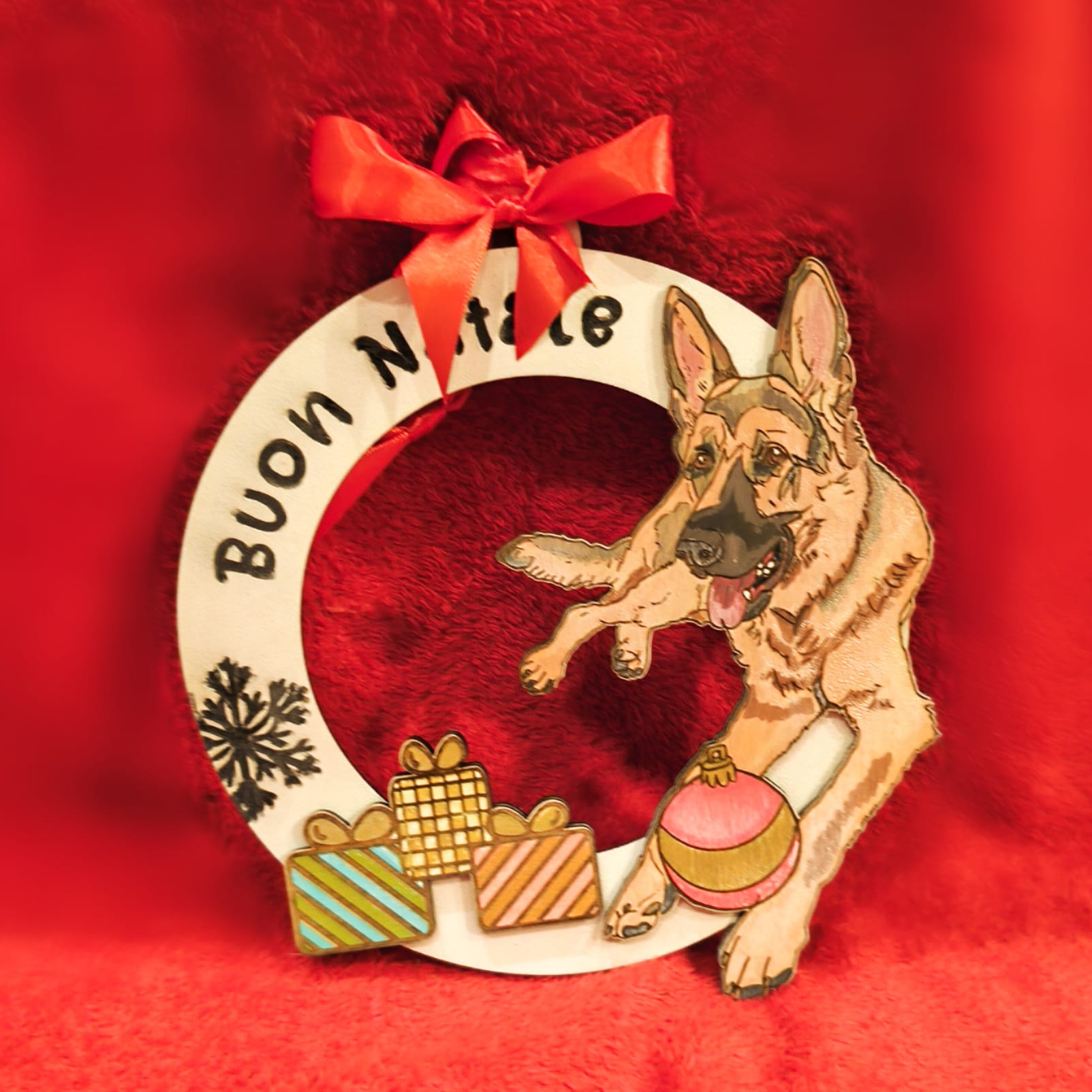 Christmas wreath with German Shepherd, gifts, red bow, Buon Natale text on red background