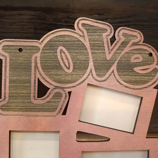 Wooden decor sign with cutout text Love and photo frames on rustic background