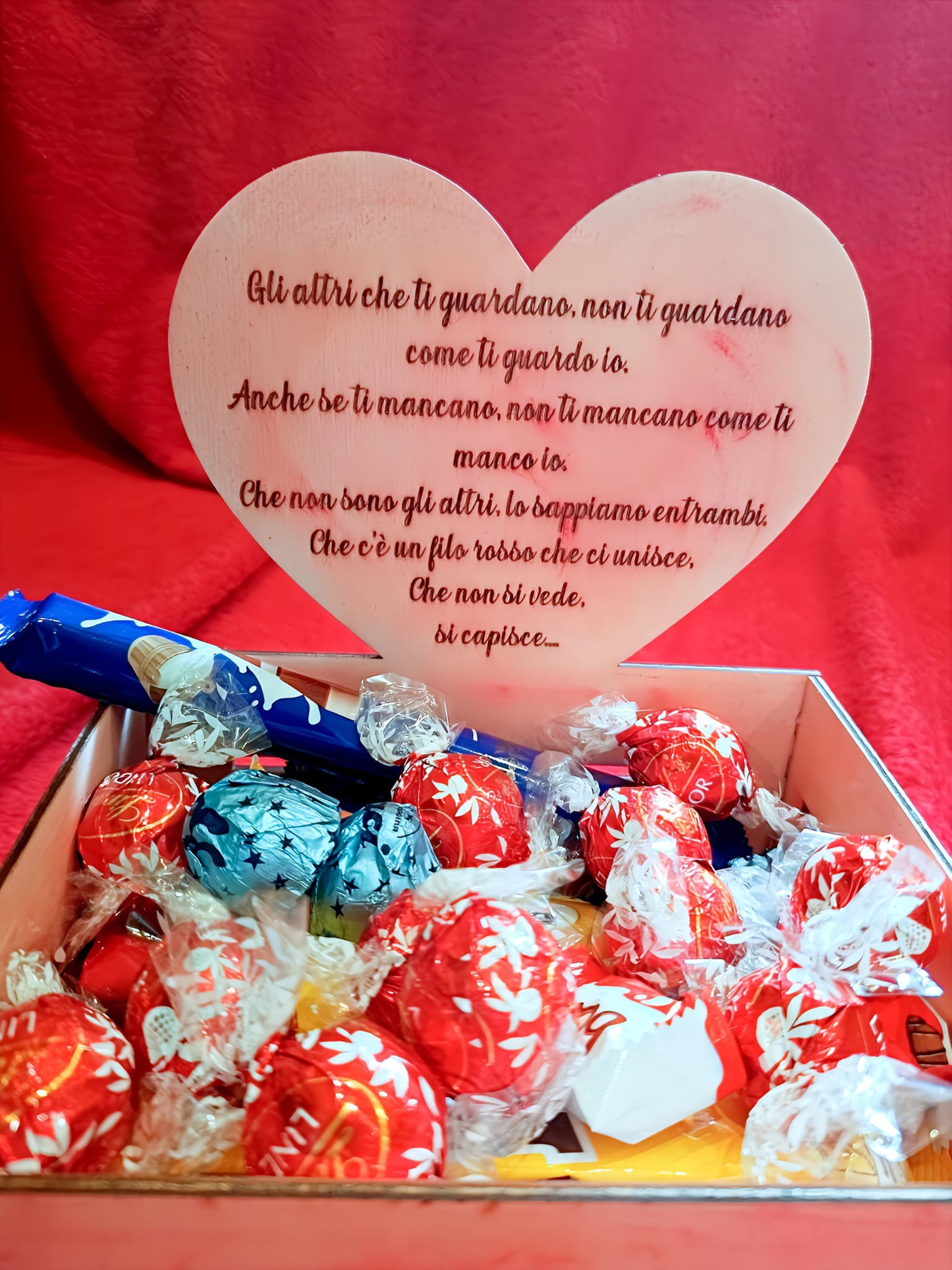 Heart-shaped card with Italian love message and assorted Lindt chocolate truffles in a gift box.