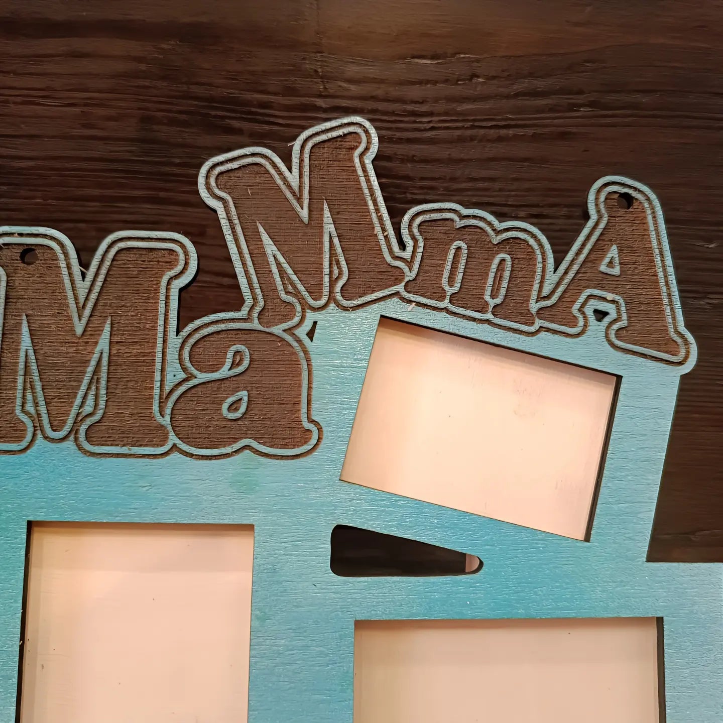 Wooden photo frame with 'Mama' text on blue background, brown wood surface
