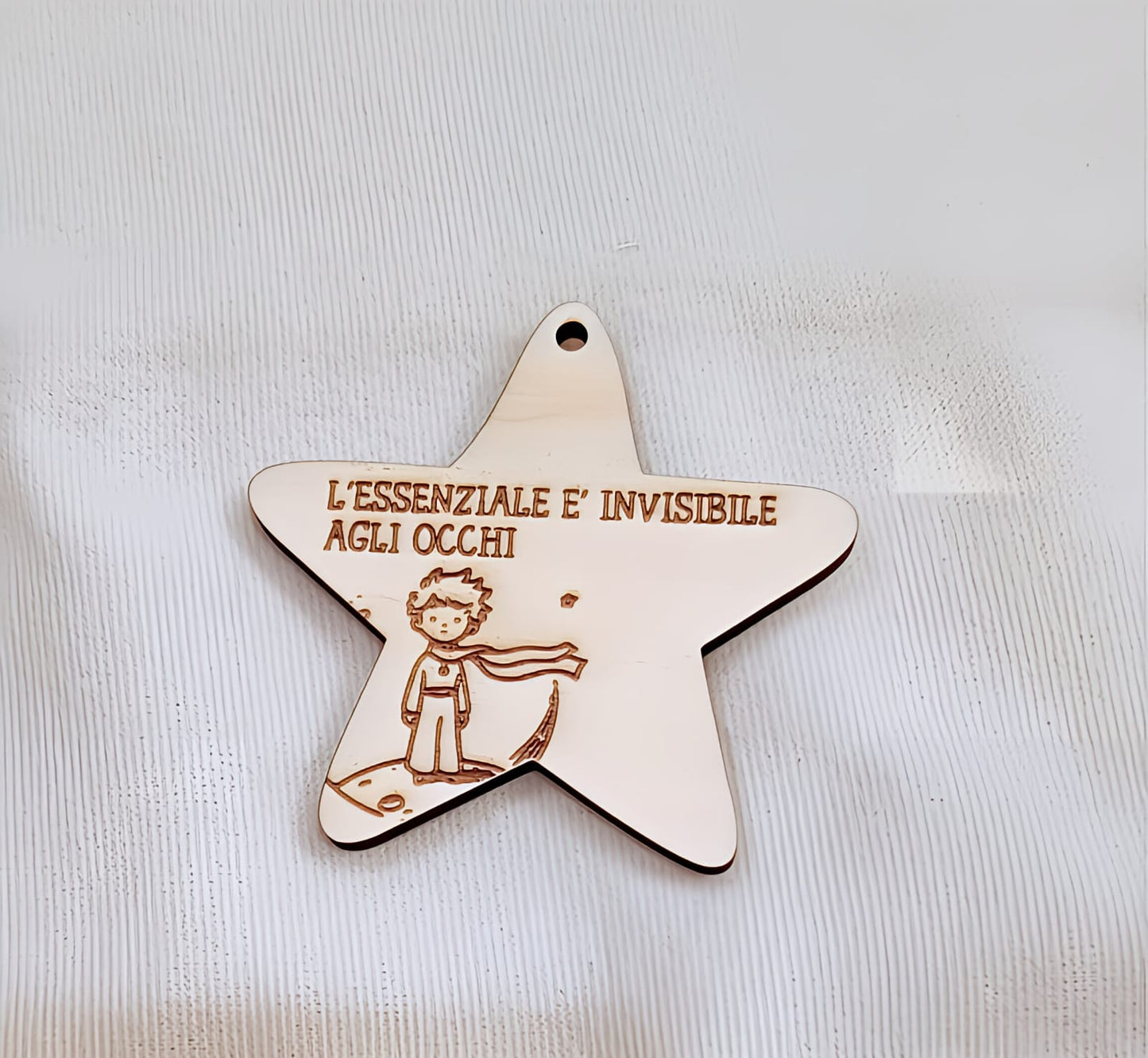 Wooden star ornament engraved with Little Prince illustration and Italian quote